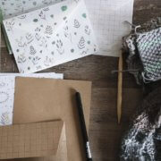 ecommerce store seller's desk with keyboard, pen, and notebook